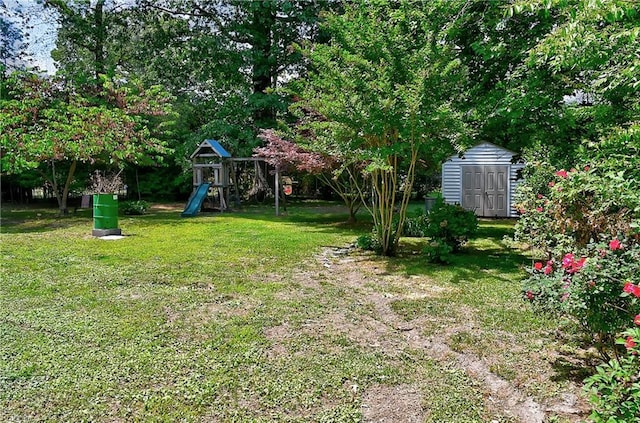view of yard featuring an outdoor structure, a playground, and a shed