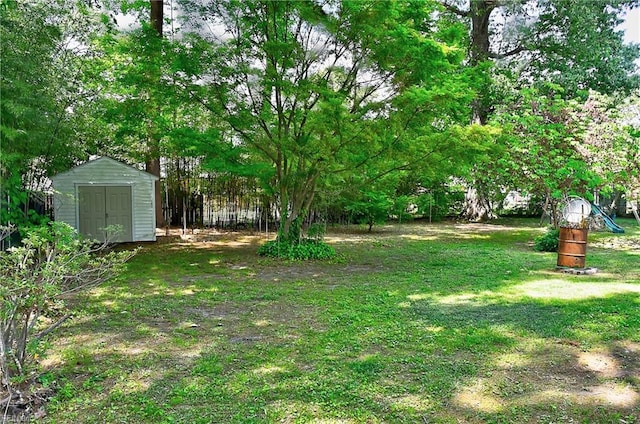 view of yard with a storage shed and an outbuilding
