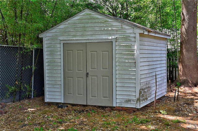 view of shed with fence