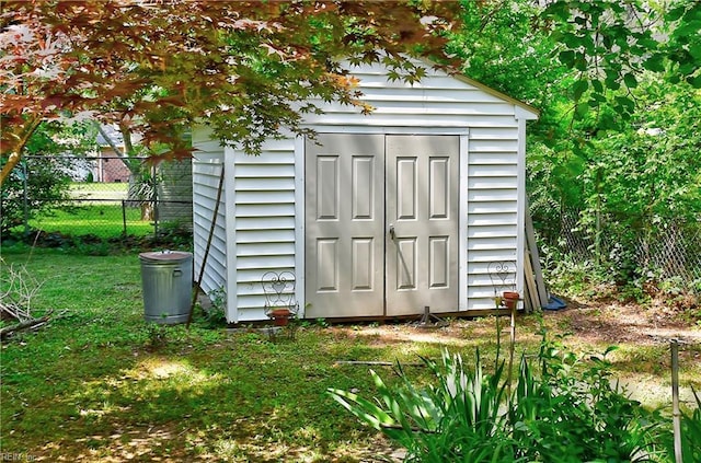view of shed with fence