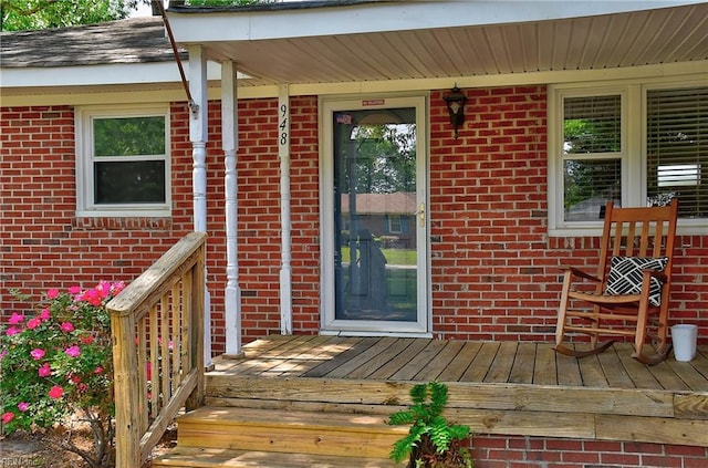 property entrance featuring brick siding