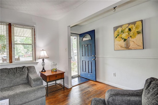 living area with baseboards and hardwood / wood-style flooring