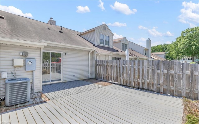 wooden deck featuring fence and cooling unit