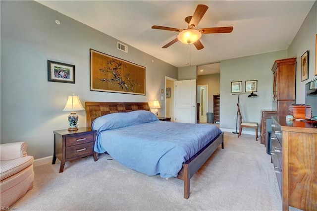 bedroom with light colored carpet, baseboards, and a ceiling fan