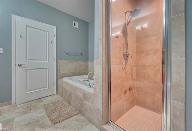 full bathroom with a shower stall, a garden tub, and tile patterned floors