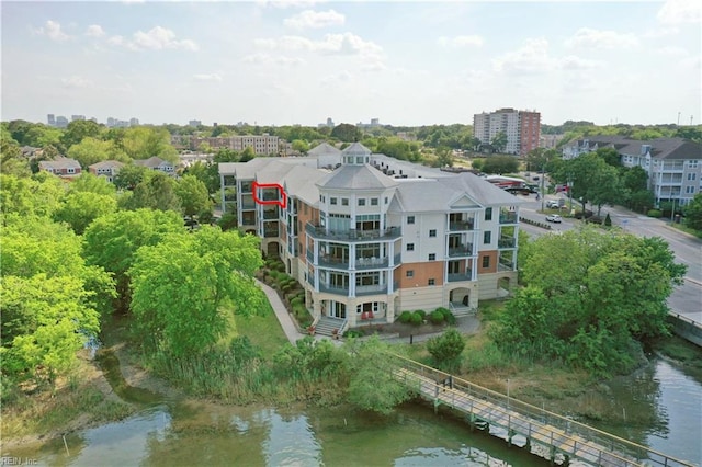 aerial view of property and surrounding area featuring a large body of water