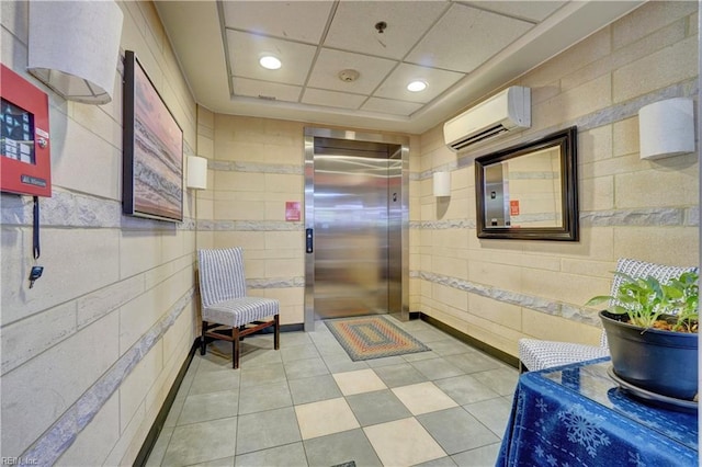 lobby with tile walls and recessed lighting