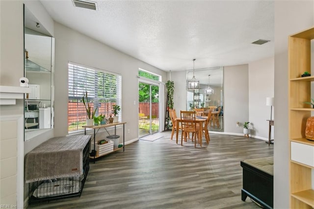 dining area featuring baseboards, visible vents, and wood finished floors