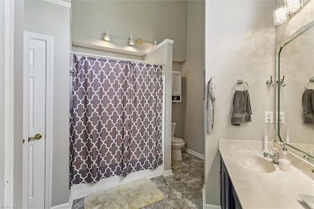 bathroom with toilet, curtained shower, and vanity