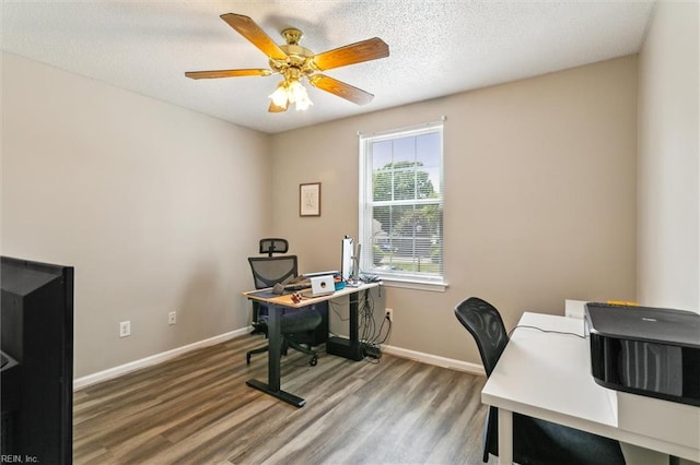 home office featuring baseboards, ceiling fan, and wood finished floors