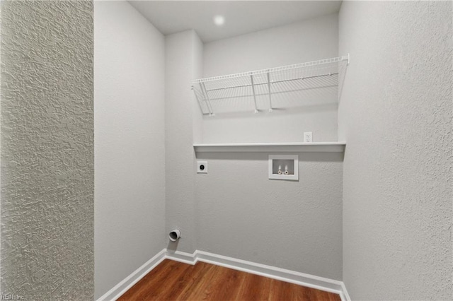 laundry room with laundry area, wood finished floors, baseboards, hookup for a washing machine, and electric dryer hookup