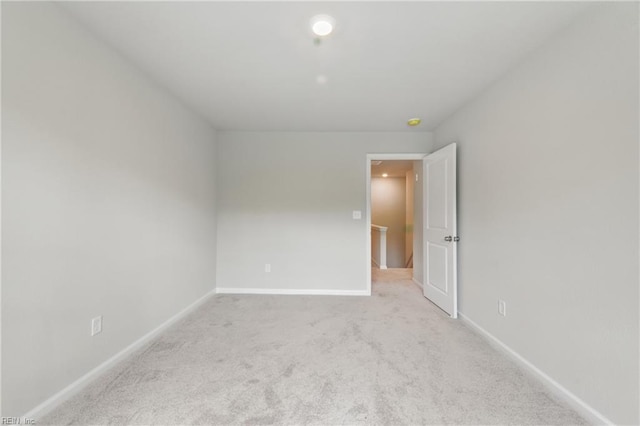 unfurnished room featuring baseboards and carpet flooring