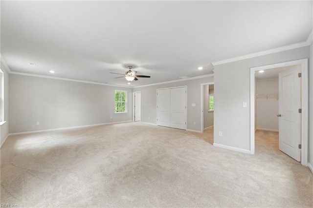 interior space with crown molding, light carpet, baseboards, ceiling fan, and recessed lighting