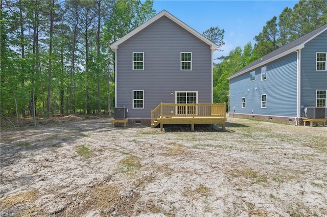 rear view of house featuring central AC, a wooden deck, and crawl space