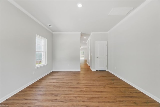 unfurnished room featuring crown molding, baseboards, recessed lighting, and wood finished floors