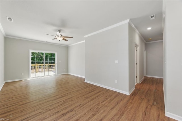 unfurnished room featuring crown molding, baseboards, ceiling fan, and visible vents