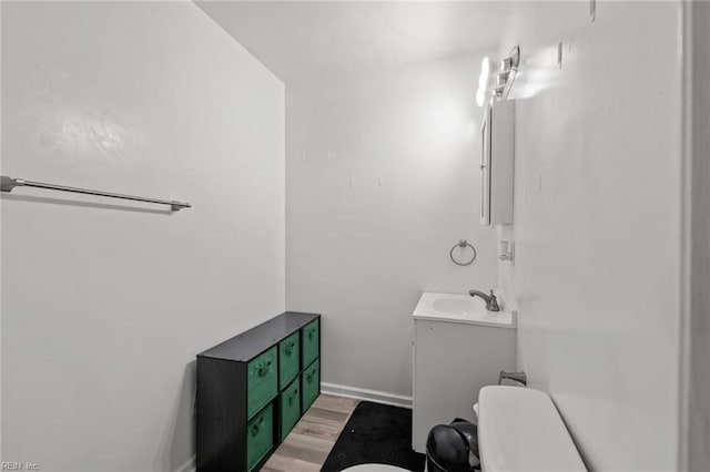 1311 24th St, Newport News, VA 23607 - half bath with vanity, baseboards, toilet, and wood finished floors