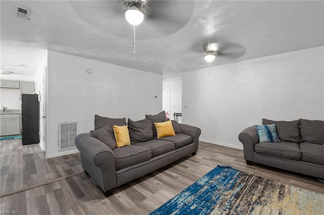 1311 24th St, Newport News, VA 23607 - living room with ceiling fan, visible vents, and wood finished floors