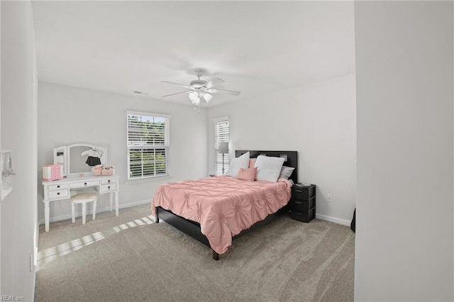 bedroom with carpet floors, baseboards, a ceiling fan, and visible vents