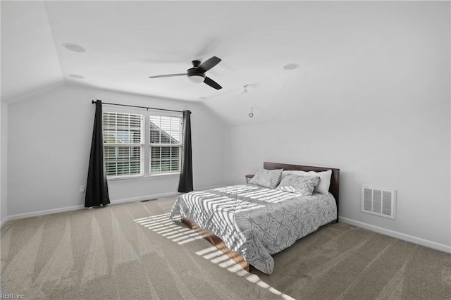 bedroom with visible vents, baseboards, carpet floors, and lofted ceiling