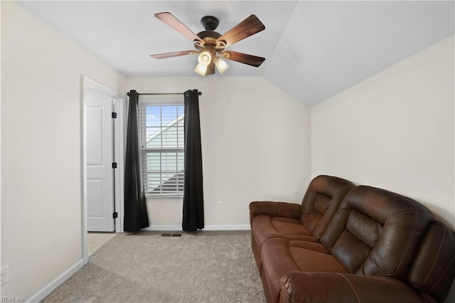 living area with light colored carpet, a ceiling fan, baseboards, vaulted ceiling, and visible vents