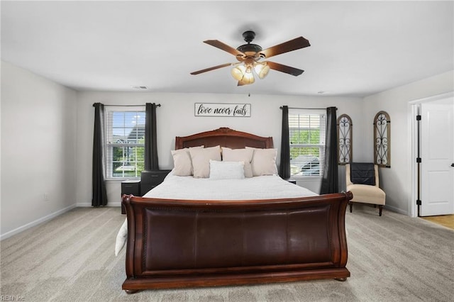 bedroom featuring baseboards, light carpet, and a ceiling fan