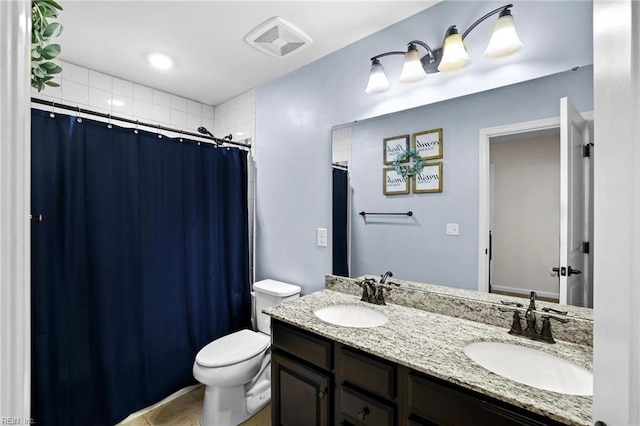 bathroom featuring a sink, toilet, double vanity, and visible vents