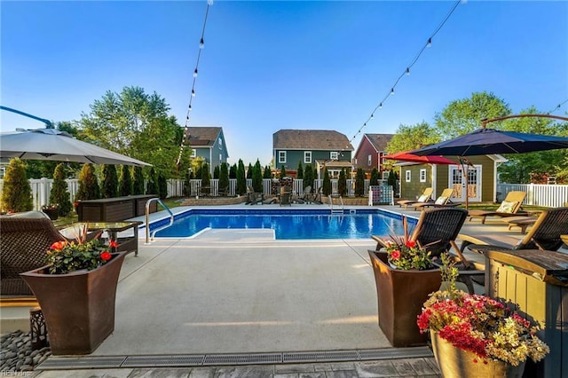 view of swimming pool with a patio, fence, and a fenced in pool