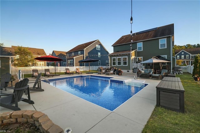 view of pool with a residential view, a fenced backyard, a fenced in pool, an outdoor living space, and a patio
