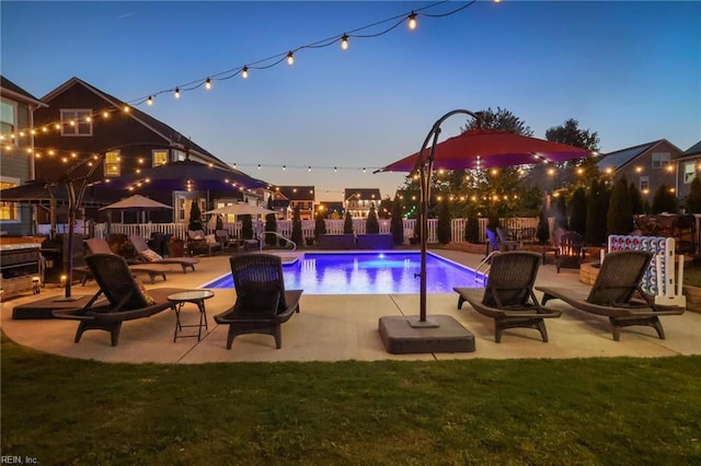 view of swimming pool featuring fence, a fenced in pool, and a patio area