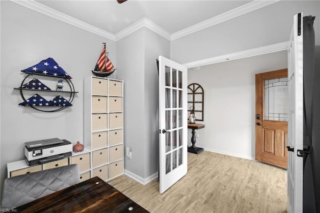 interior space featuring crown molding, baseboards, wood finished floors, and french doors