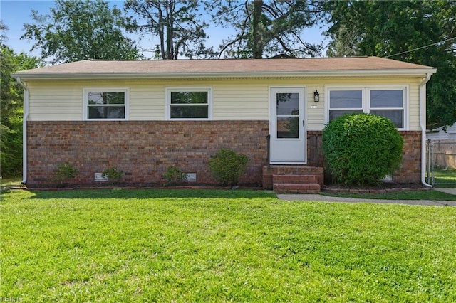 bungalow-style house featuring fence, a front lawn, brick siding, crawl space, and entry steps