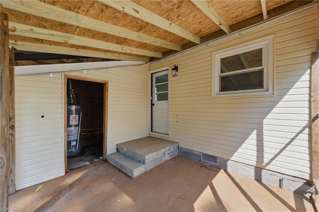 view of patio with visible vents and gas water heater
