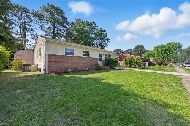 ranch-style house with brick siding, a front lawn, and driveway