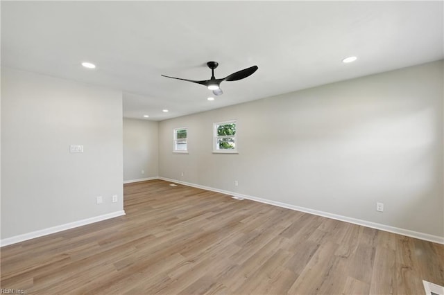 empty room featuring baseboards, a ceiling fan, light wood-style floors, and recessed lighting