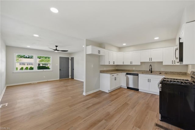 kitchen with baseboards, a sink, appliances with stainless steel finishes, and ceiling fan