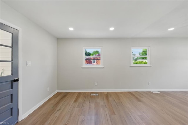 empty room featuring recessed lighting, baseboards, visible vents, and light wood-style flooring