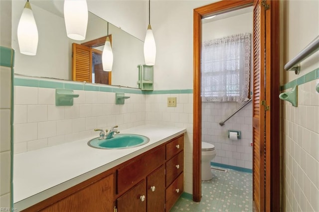 1365 Old Buckroe Rd, Hampton, VA 23663 - bathroom featuring tile walls, a wainscoted wall, vanity, and toilet