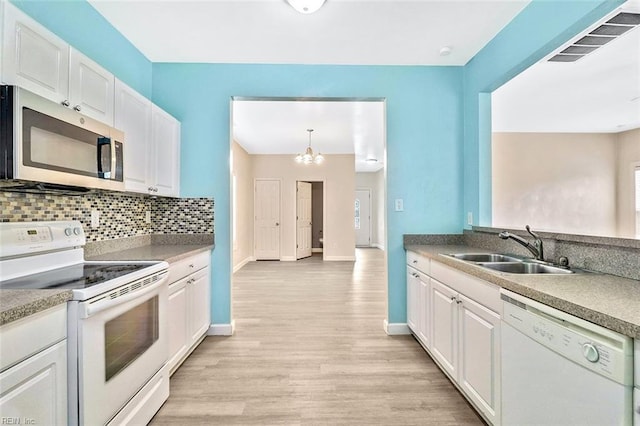 2100 Ruth St, Chesapeake, VA 23324 - kitchen with white appliances, a sink, white cabinets, light wood finished floors, and baseboards