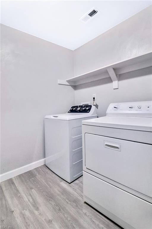 2100 Ruth St, Chesapeake, VA 23324 - laundry room featuring independent washer and dryer, light wood-type flooring, and baseboards