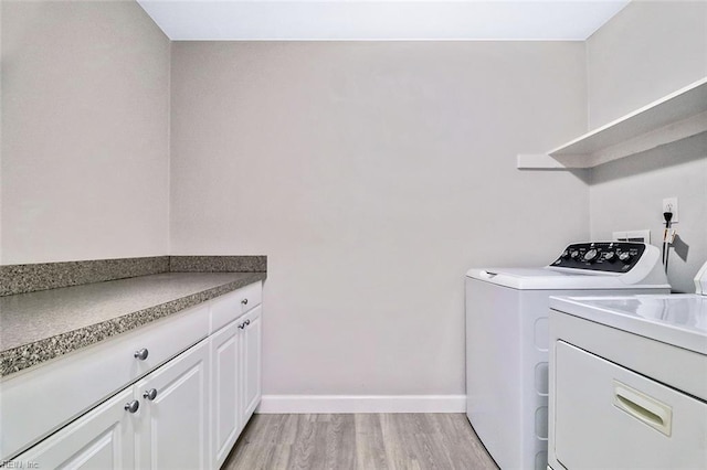 2100 Ruth St, Chesapeake, VA 23324 - laundry room with washing machine and clothes dryer, light wood-style flooring, baseboards, and cabinet space