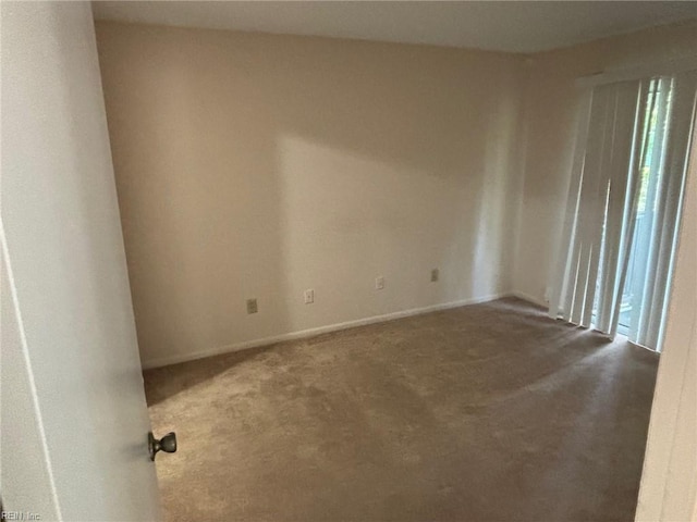 empty room with carpet floors and baseboards