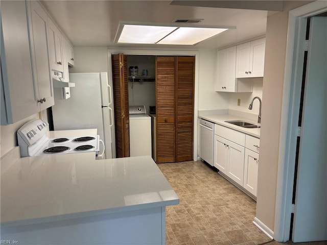 kitchen with visible vents, washer / dryer, white appliances, white cabinetry, and a sink