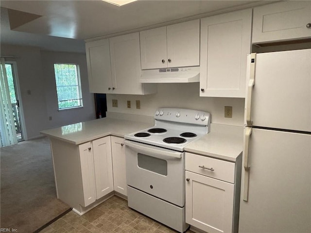 kitchen with a peninsula, white appliances, light countertops, under cabinet range hood, and white cabinets