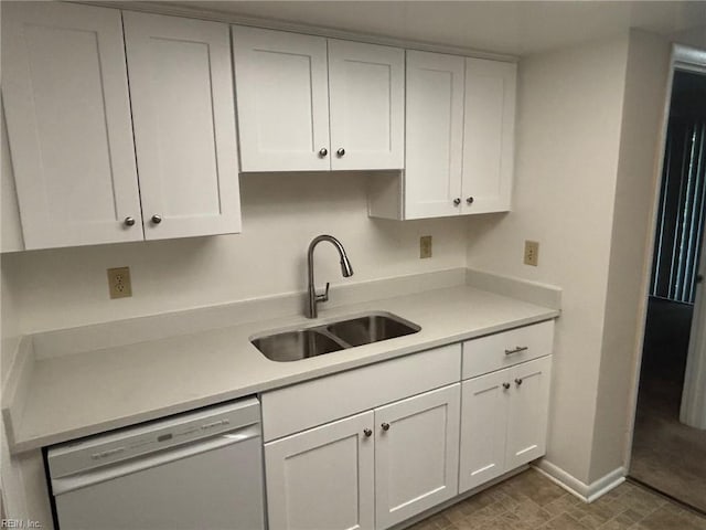 kitchen featuring a sink, light countertops, stainless steel dishwasher, and white cabinetry