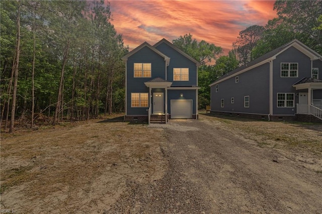 view of front of home featuring a garage, driveway, and crawl space