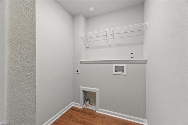 laundry area featuring laundry area, hookup for a washing machine, baseboards, wood finished floors, and hookup for an electric dryer