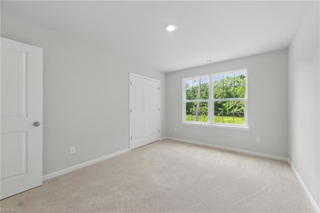 carpeted spare room with baseboards