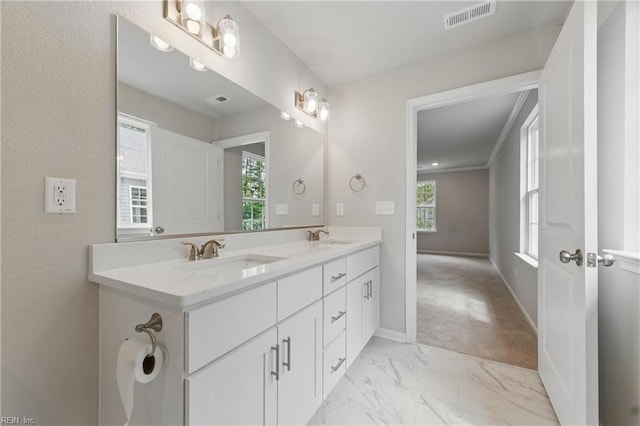 bathroom with a sink, marble finish floor, double vanity, and visible vents