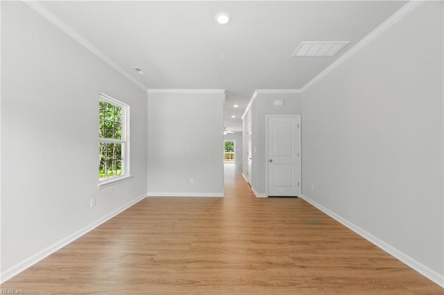 unfurnished room featuring visible vents, baseboards, light wood finished floors, ornamental molding, and recessed lighting